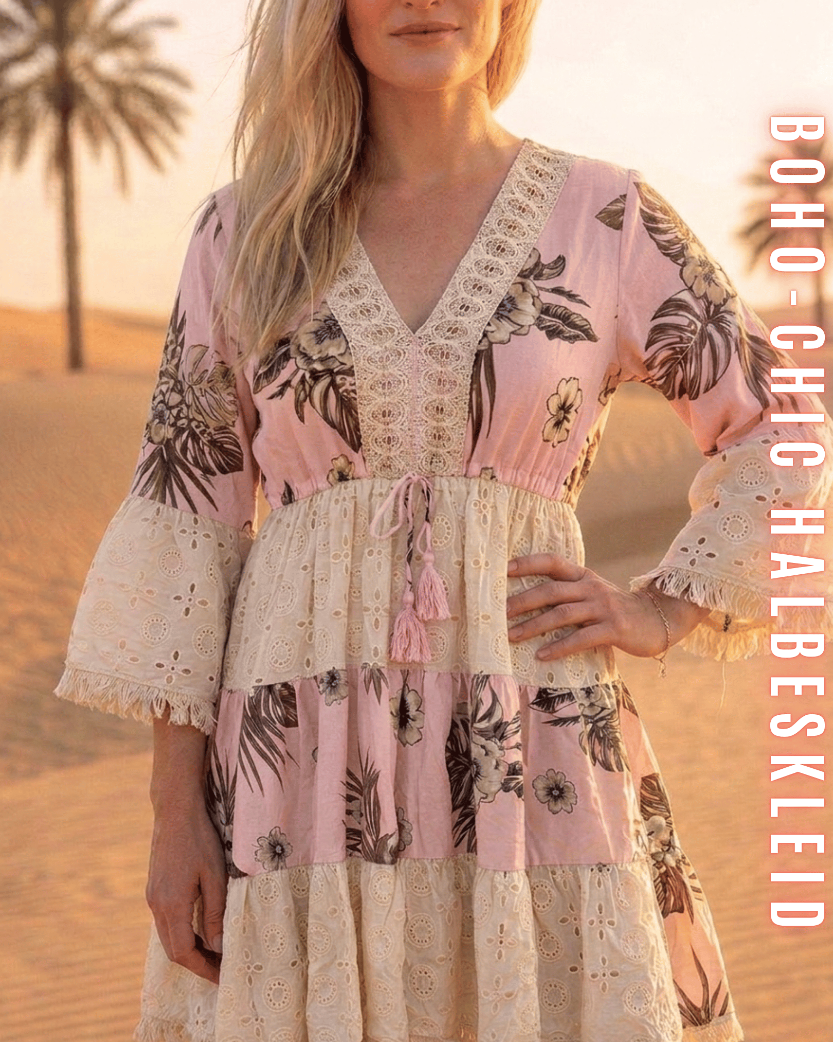 Nahaufnahme des rosa Boho-Stufenkleids mit V-Ausschnitt, floralem Muster und hellen Quasten.