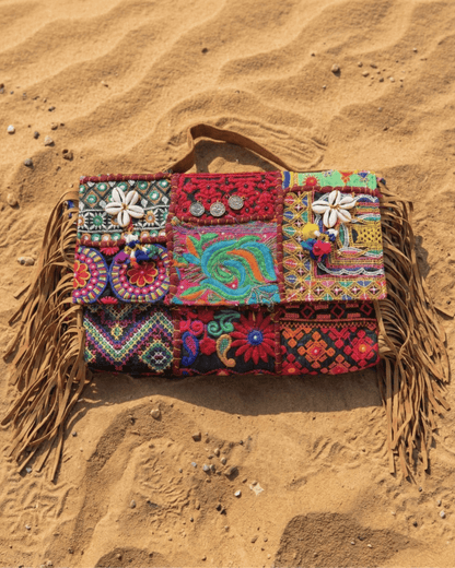 Nahaufnahme der großflächigen Handstickerei und der metallischen Verzierungen am oberen Rand.