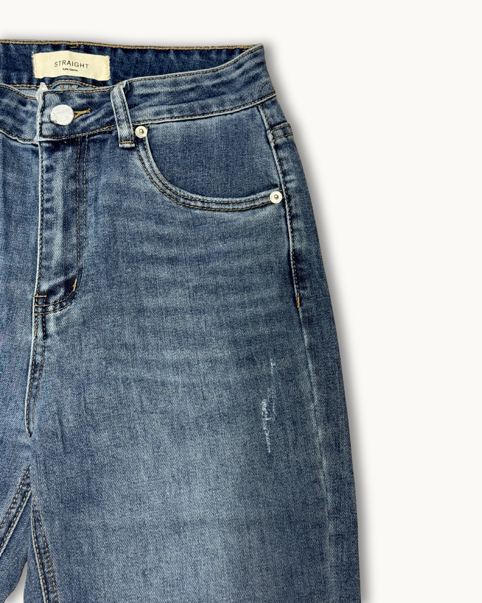 Nahaufnahme des Hosenbunds und der vorderen Tasche der Denim-Jeans mit sichtbarem "Straight"-Label.
