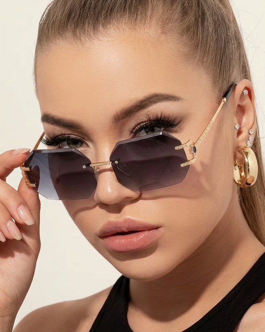 ELEXUA Octagon Sonnenbrille randlos mit dunkel getönten Gläsern und goldenen Bügeln.