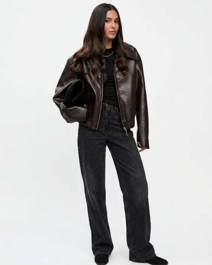 Streetwear Outfit: Weite braune Lederjacke kombiniert mit weiter schwarzer Jeans und Tasche